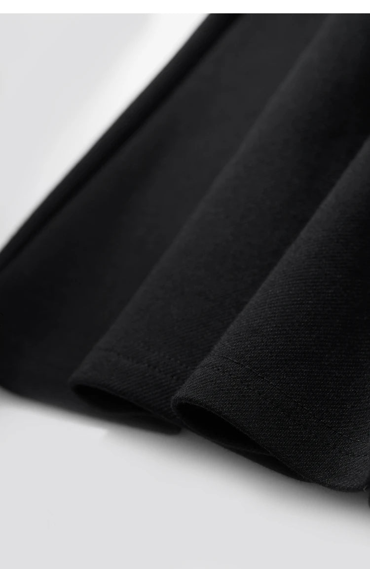 Close up of the hem of a black dress.