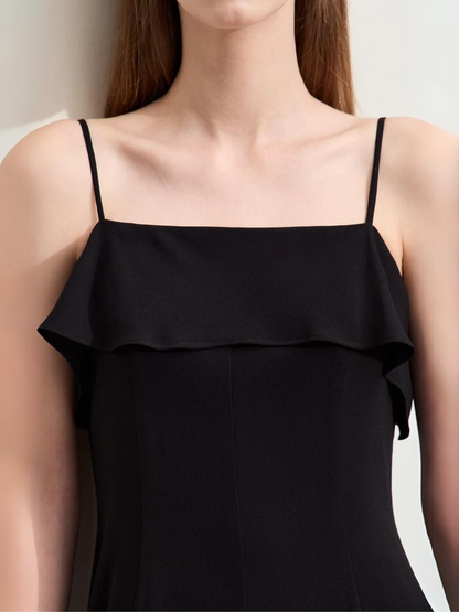 Close up of the bodice of a minimalist and simple dress featuring thin straps and a ruffle design.