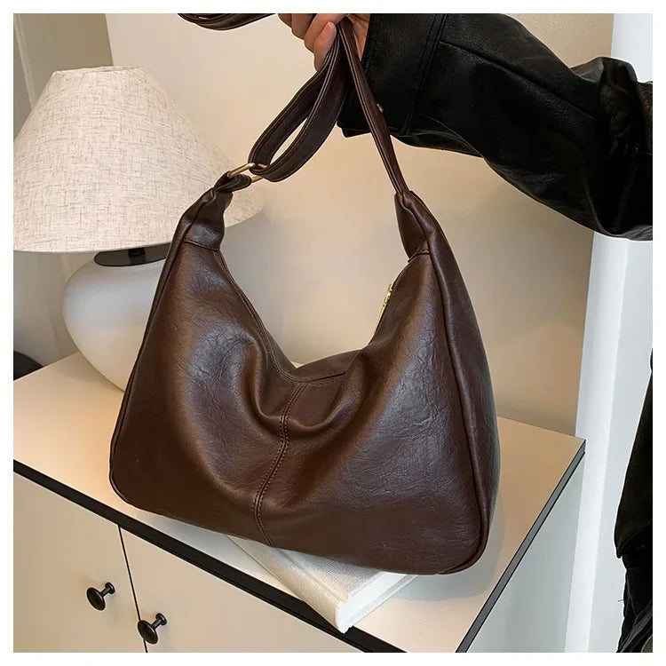 Braun-schwarze Novira Tasche mit geflochtenem Riemen