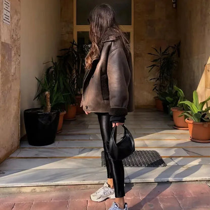 Frau trägt Nevada Luxe Winterjacke in Dunkelbraun auf der Straße
